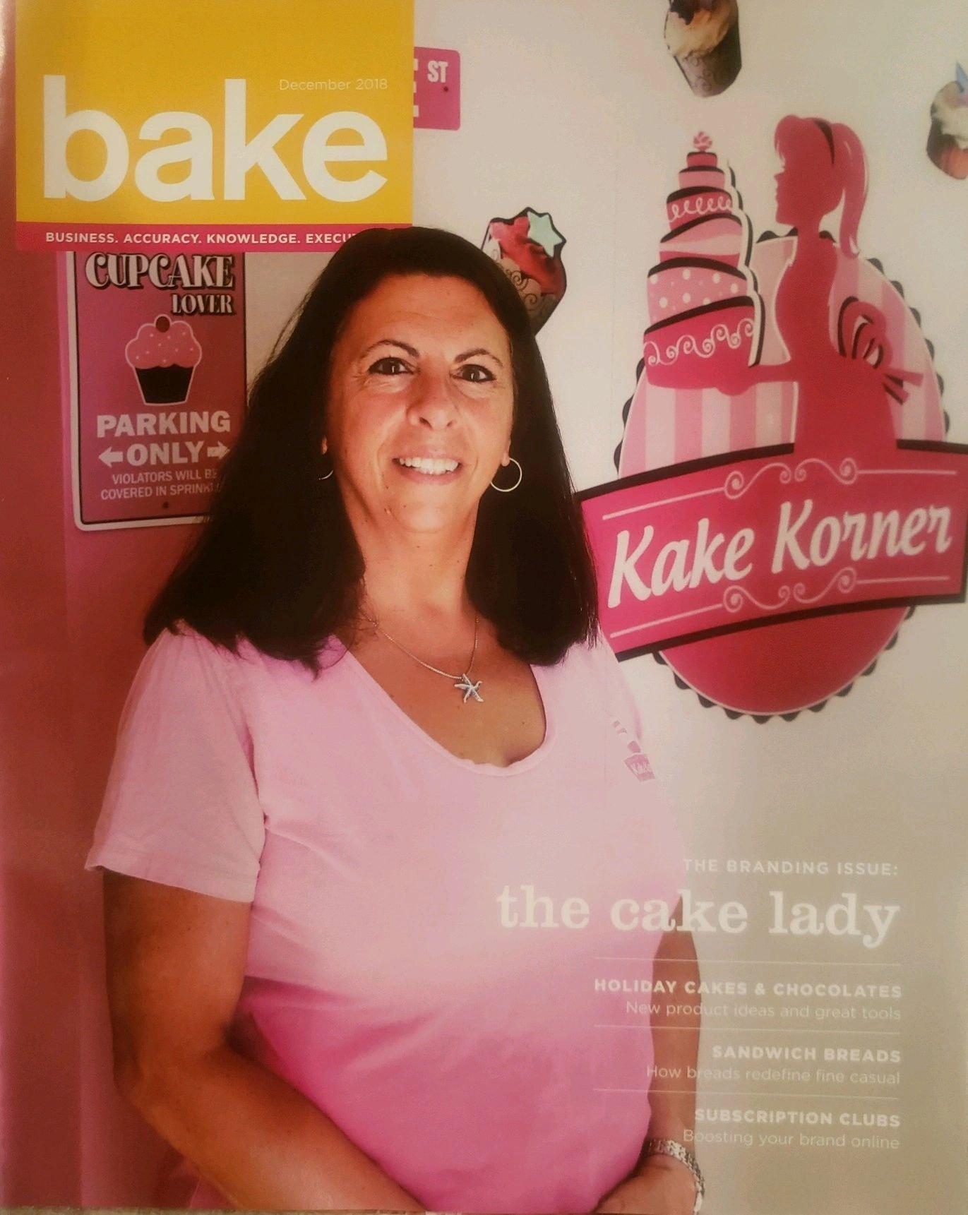 Woman posing with bakery wall decor